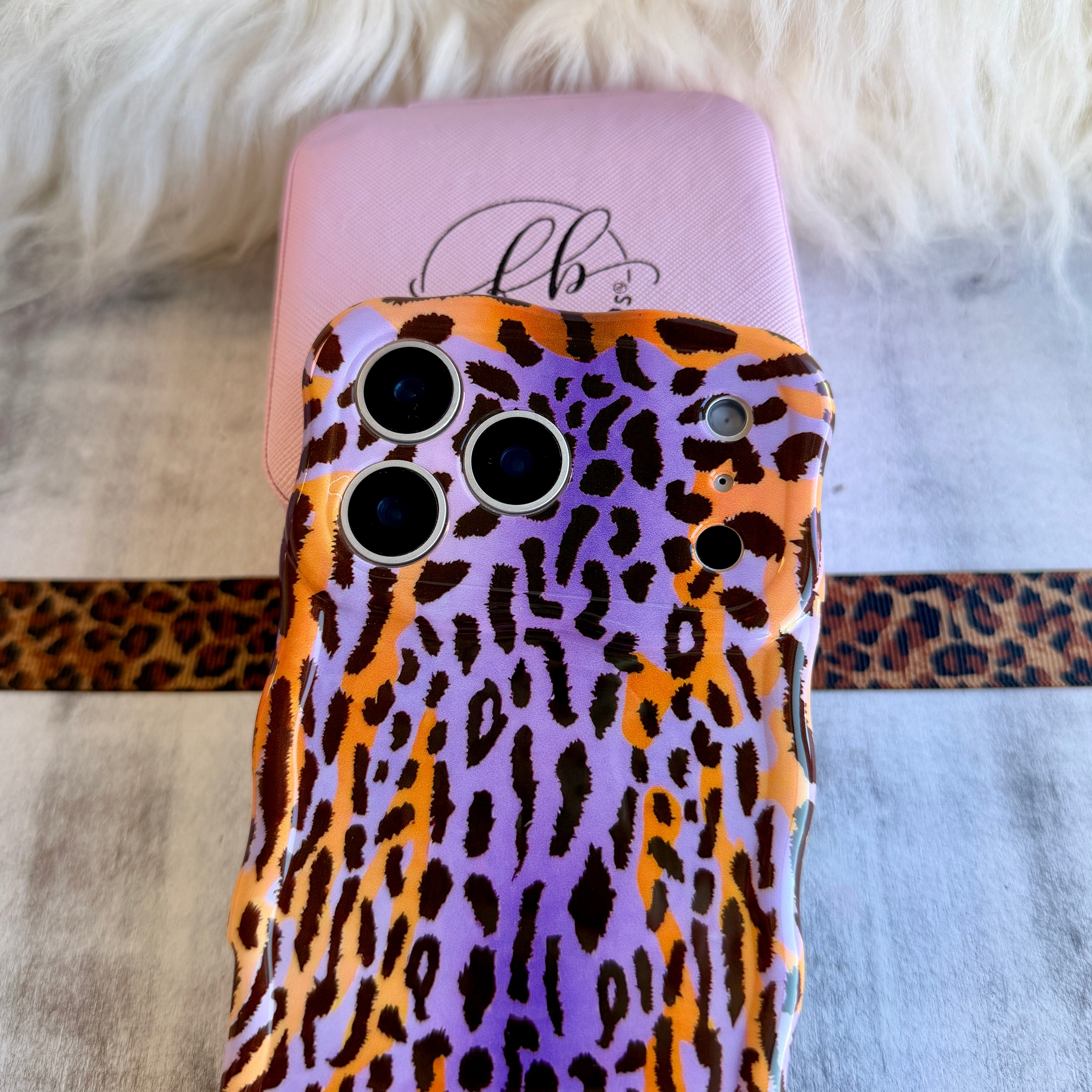 Purr-ple Haze MagSafe iPhone case with purple and orange leopard print by Fancy Bands