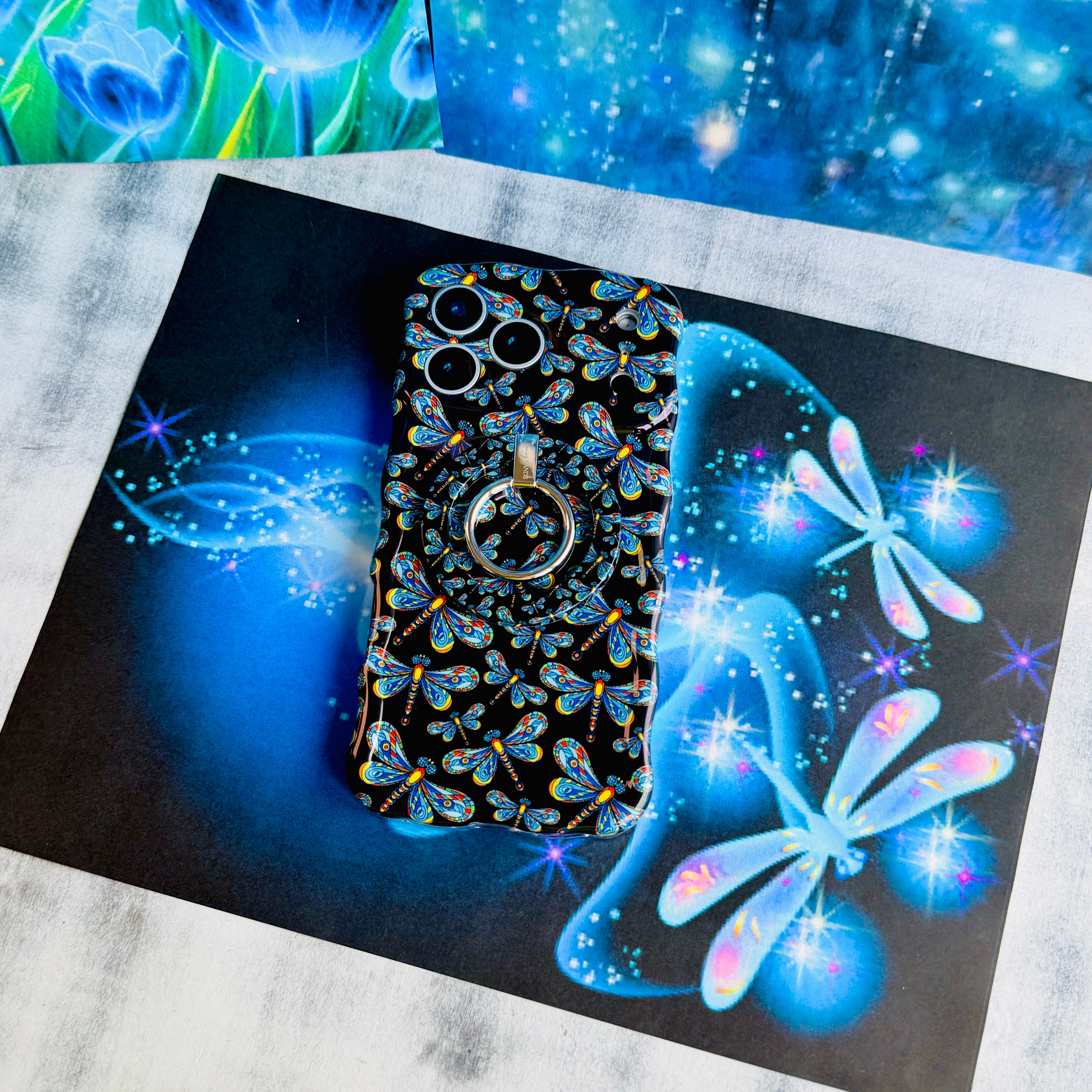 Dragonfly Dreams pattern MagSafe phone grip ring with colorful stained-glass style dragonflies on a black background compatible with iPhone and Samsung