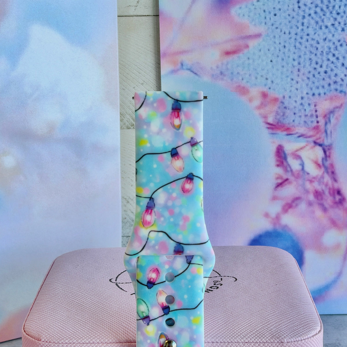 Close-up of a single Twinkle All The Way Samsung watch band strap, pastel Christmas bulbs on aqua