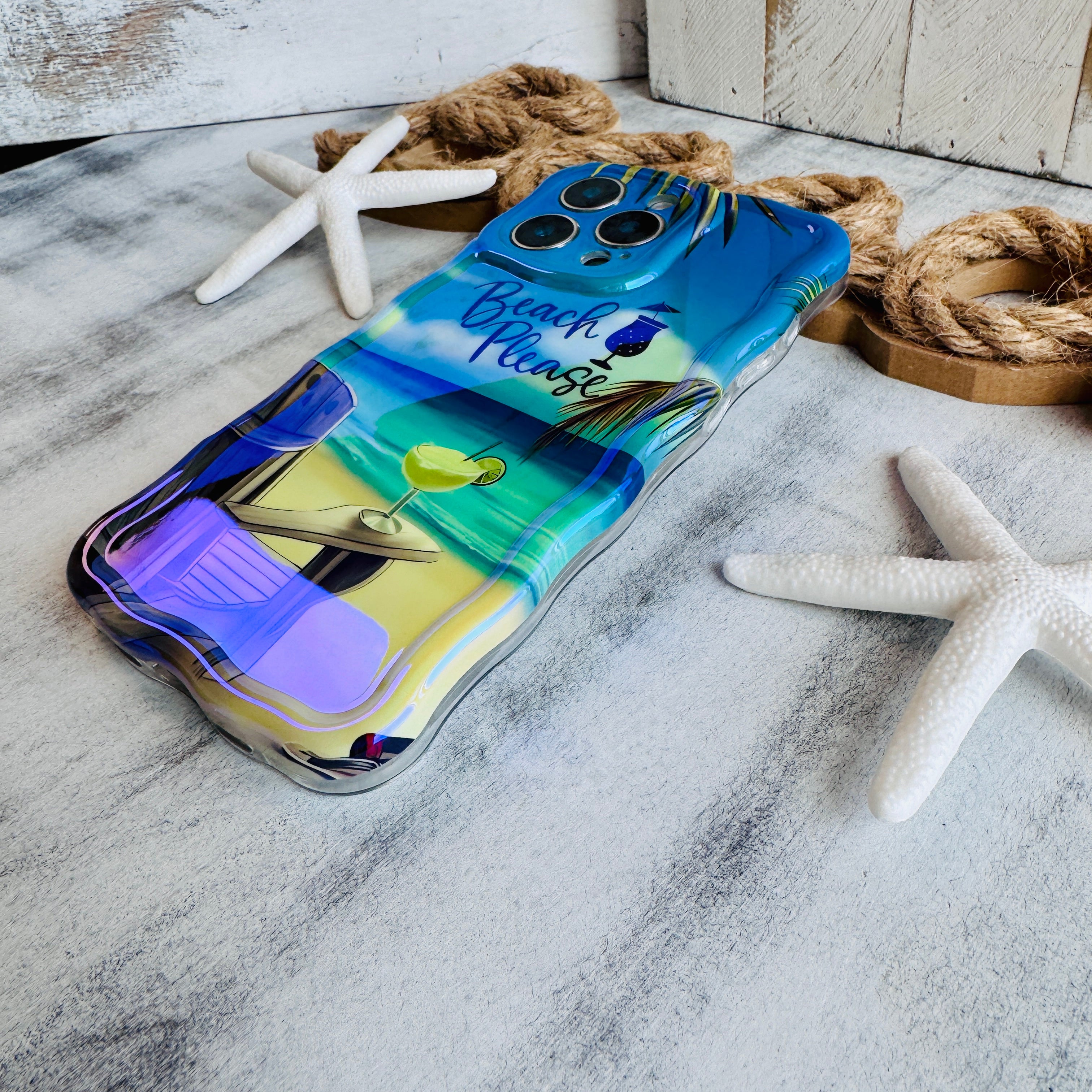 Phone case with beach theme on marble surface with starfish and rope.