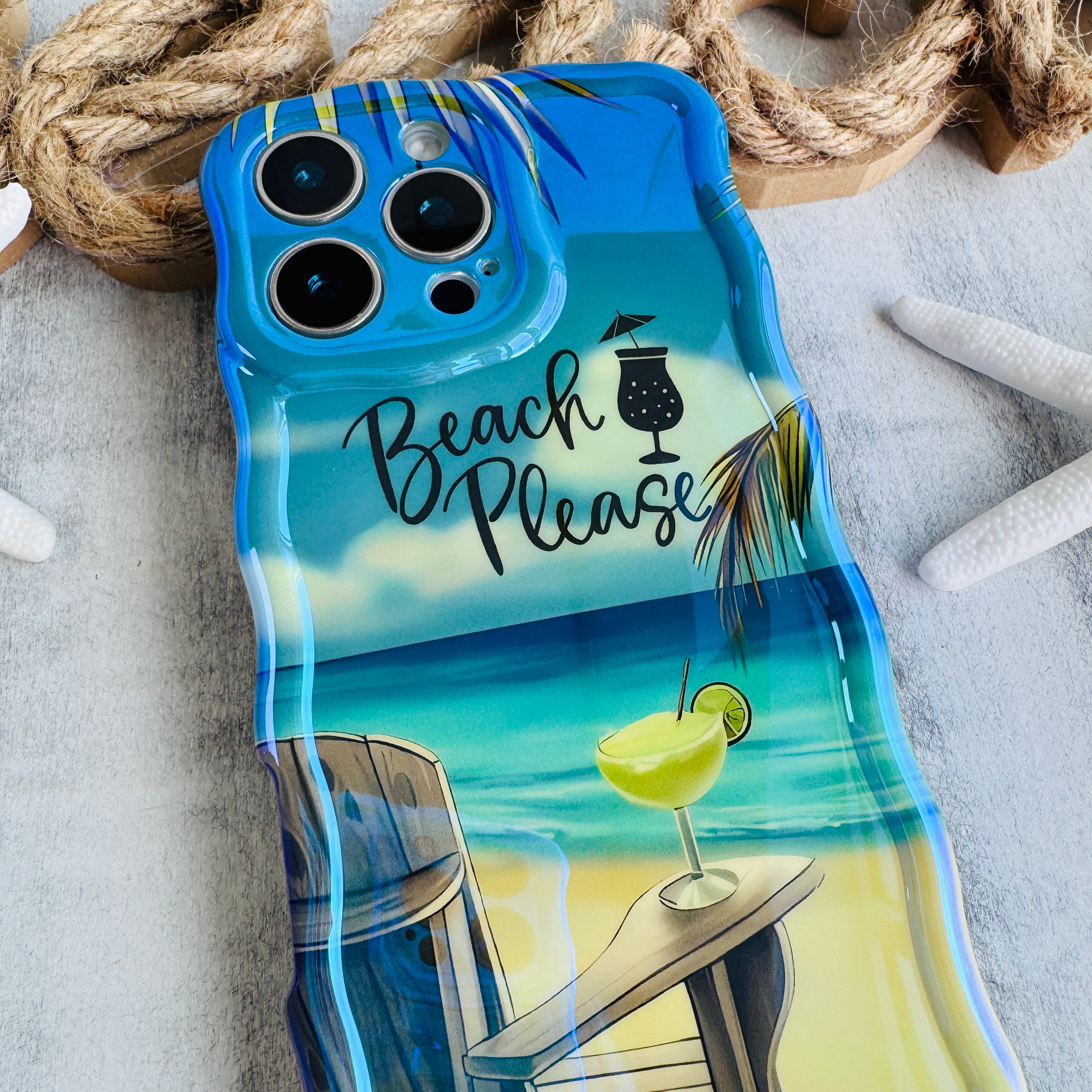 Phone case with beach-themed design including a cocktail and lounge chair.