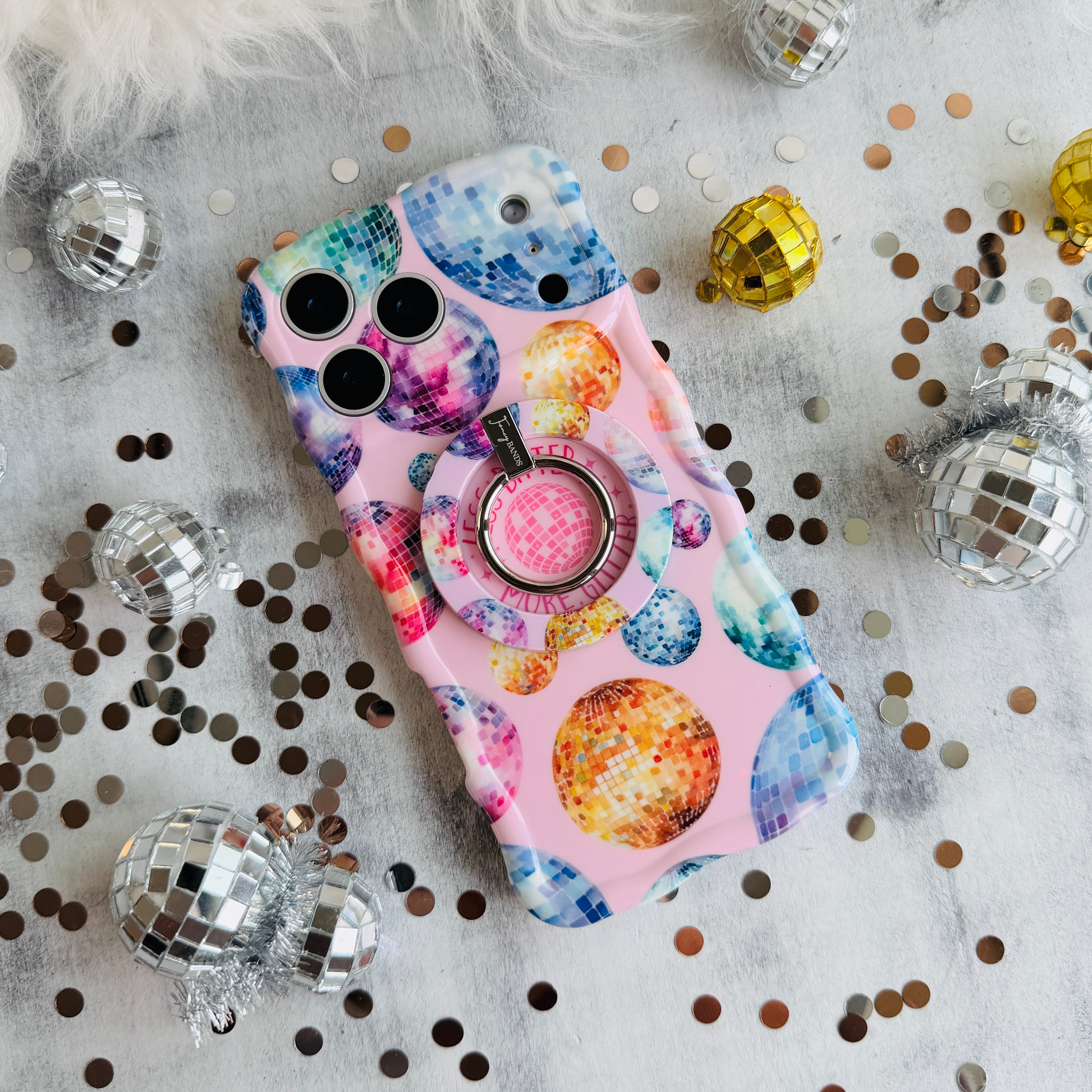 Colorful disco ball pattern MagSafe phone grip ring and stand on pink background compatible with iPhone and Samsung