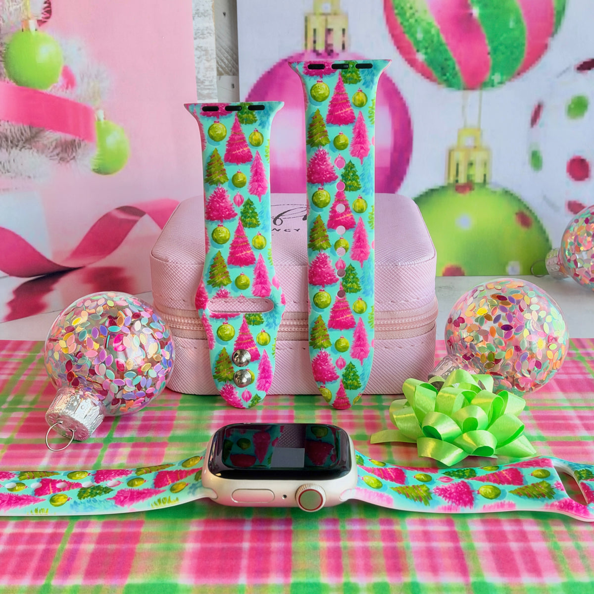 Merry & Bright, Totally! Apple Watch band shown on an Apple Watch and as two straps on a pink jewelry box, pink and lime Christmas trees on aqua