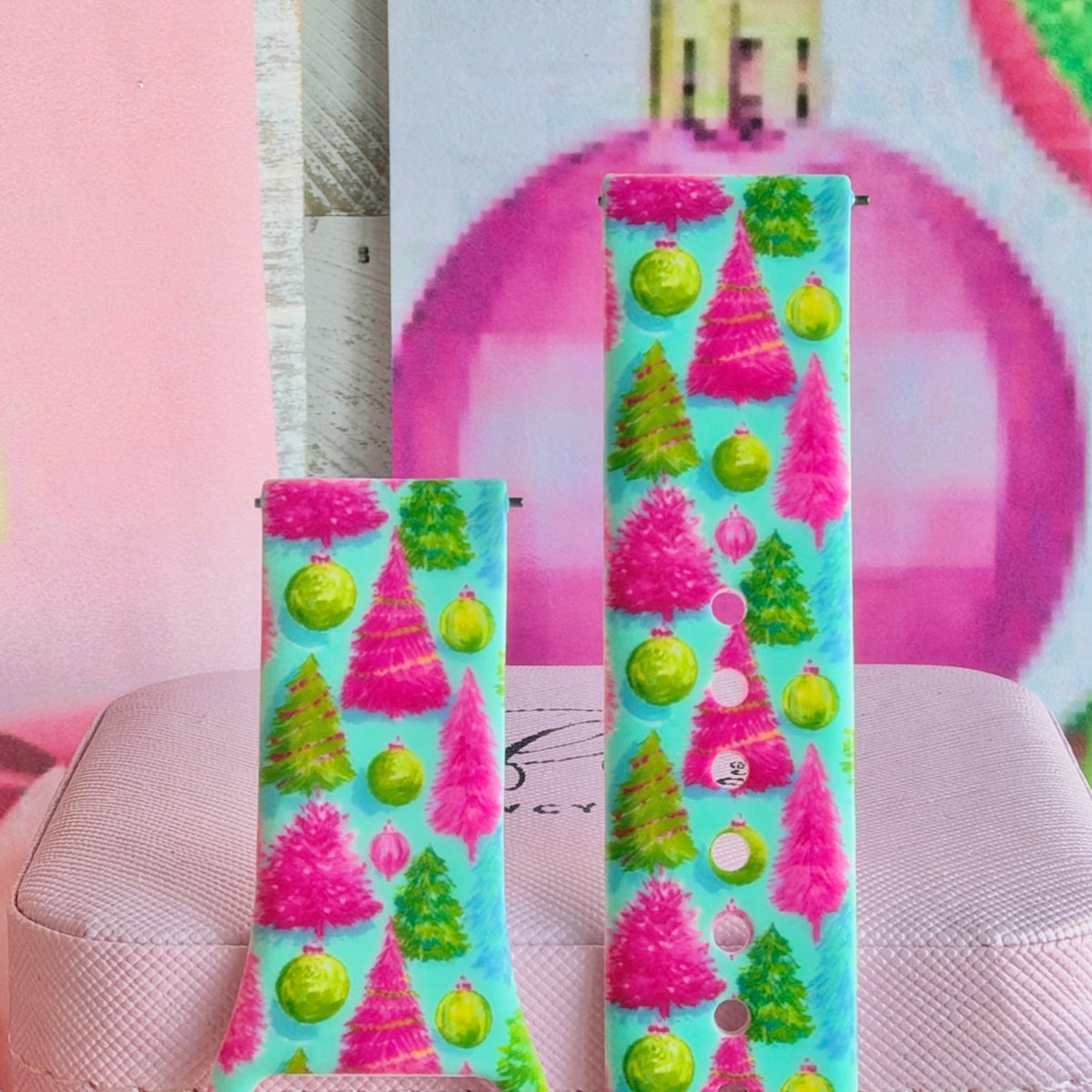 Close-up of both Merry & Bright, Totally! Samsung Galaxy Watch band straps with hot pink and lime Christmas trees on aqua