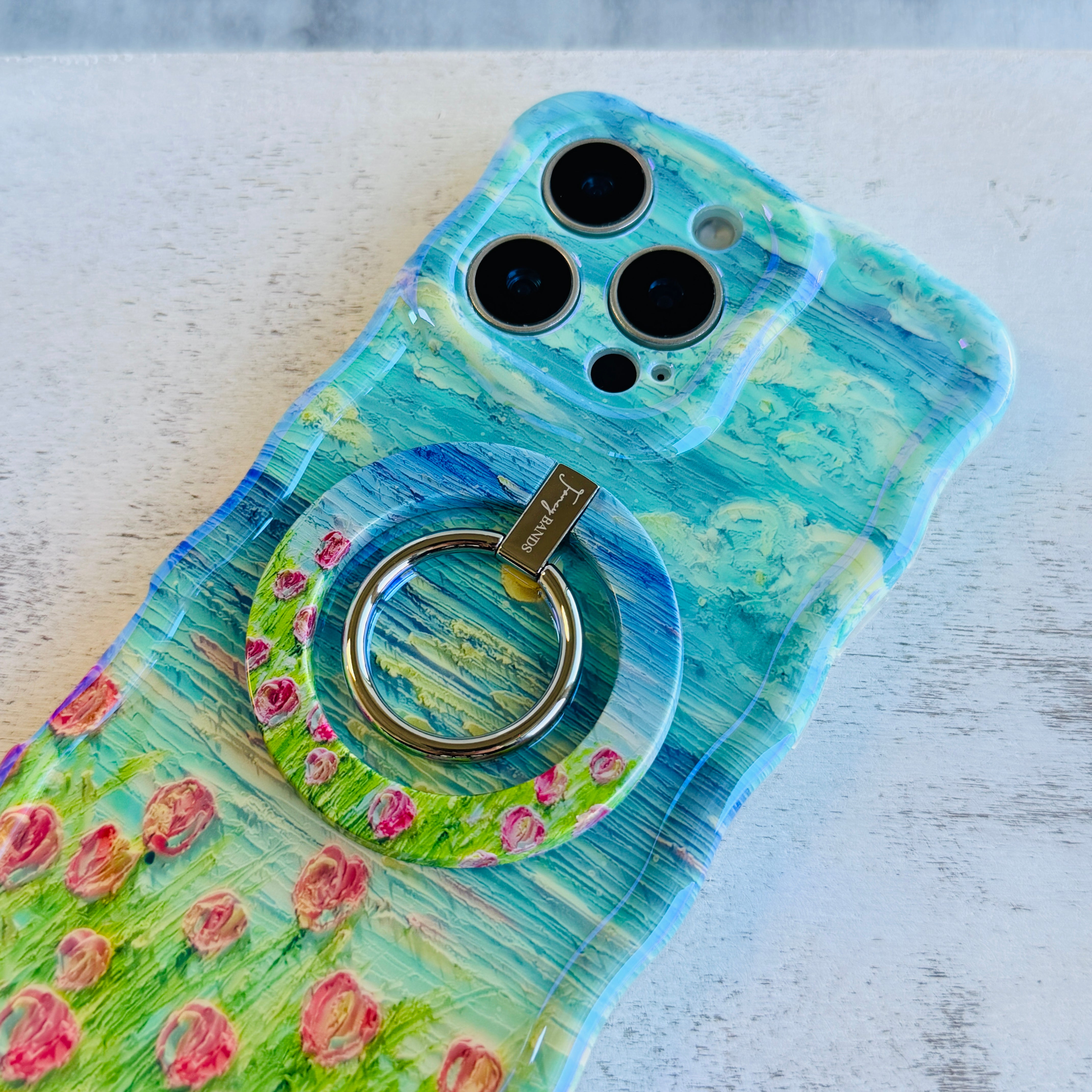 Coastal Bloom oil painting style MagSafe phone grip ring with blue sky and pink wildflowers compatible with iPhone and Samsung
