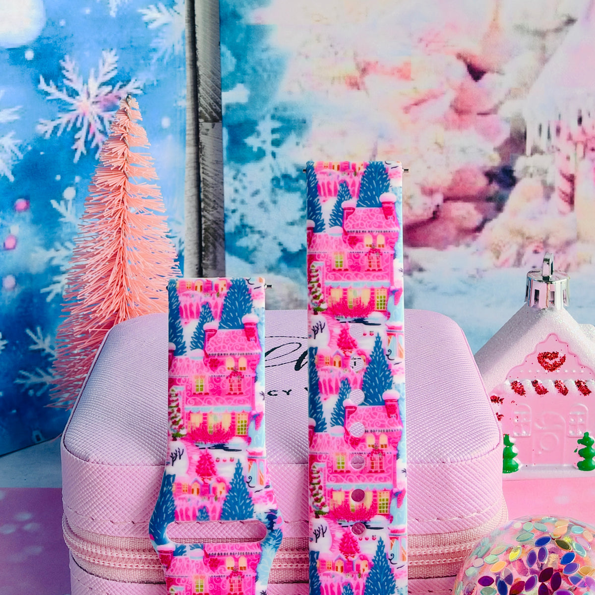 Close-up of both Sugarplum Square Samsung Galaxy Watch band straps with pink gingerbread houses and blue pines