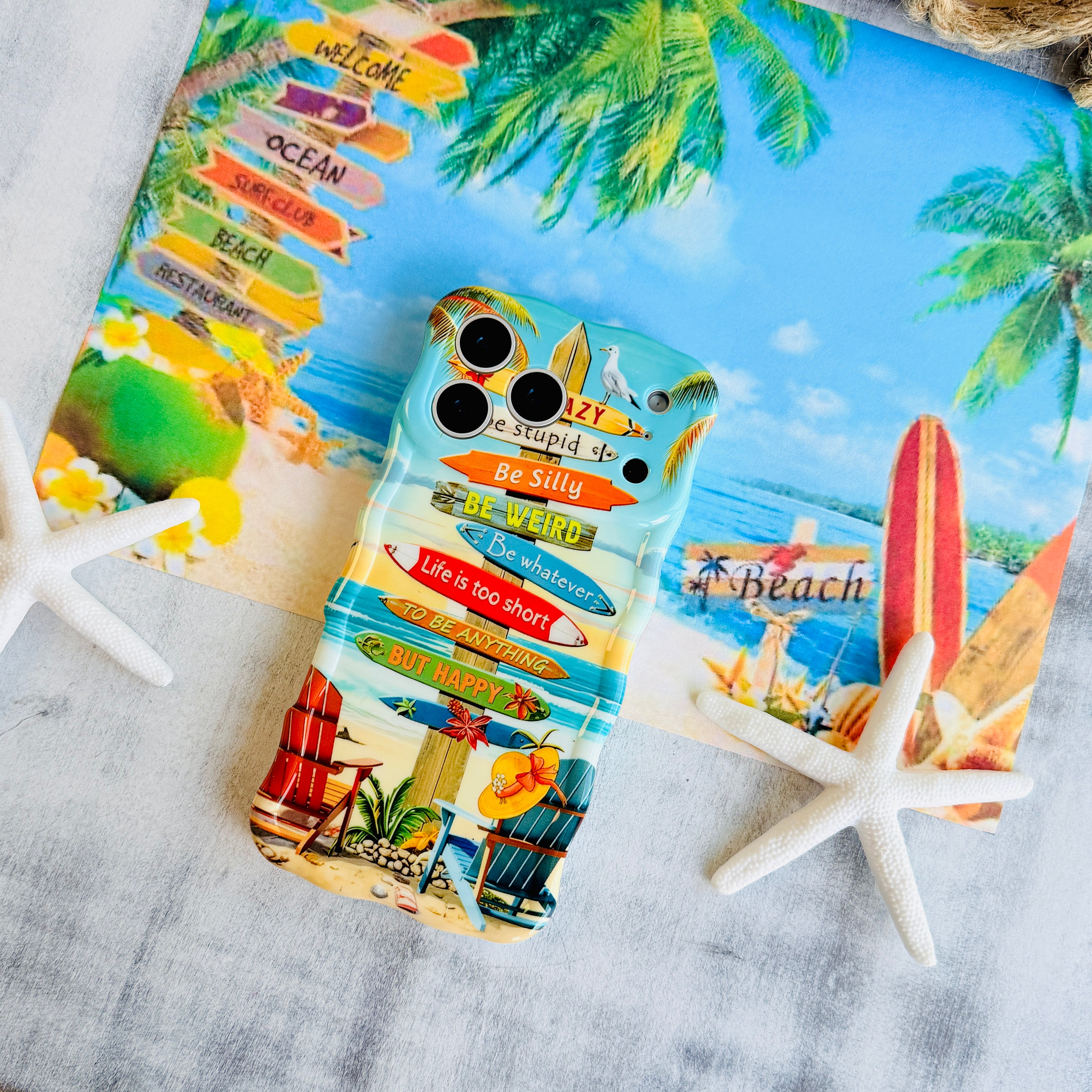 Trendy wavy iPhone case featuring a beach scene with colorful surfboard signs and a "Life is too short to be happy" quote with a high-gloss finish.