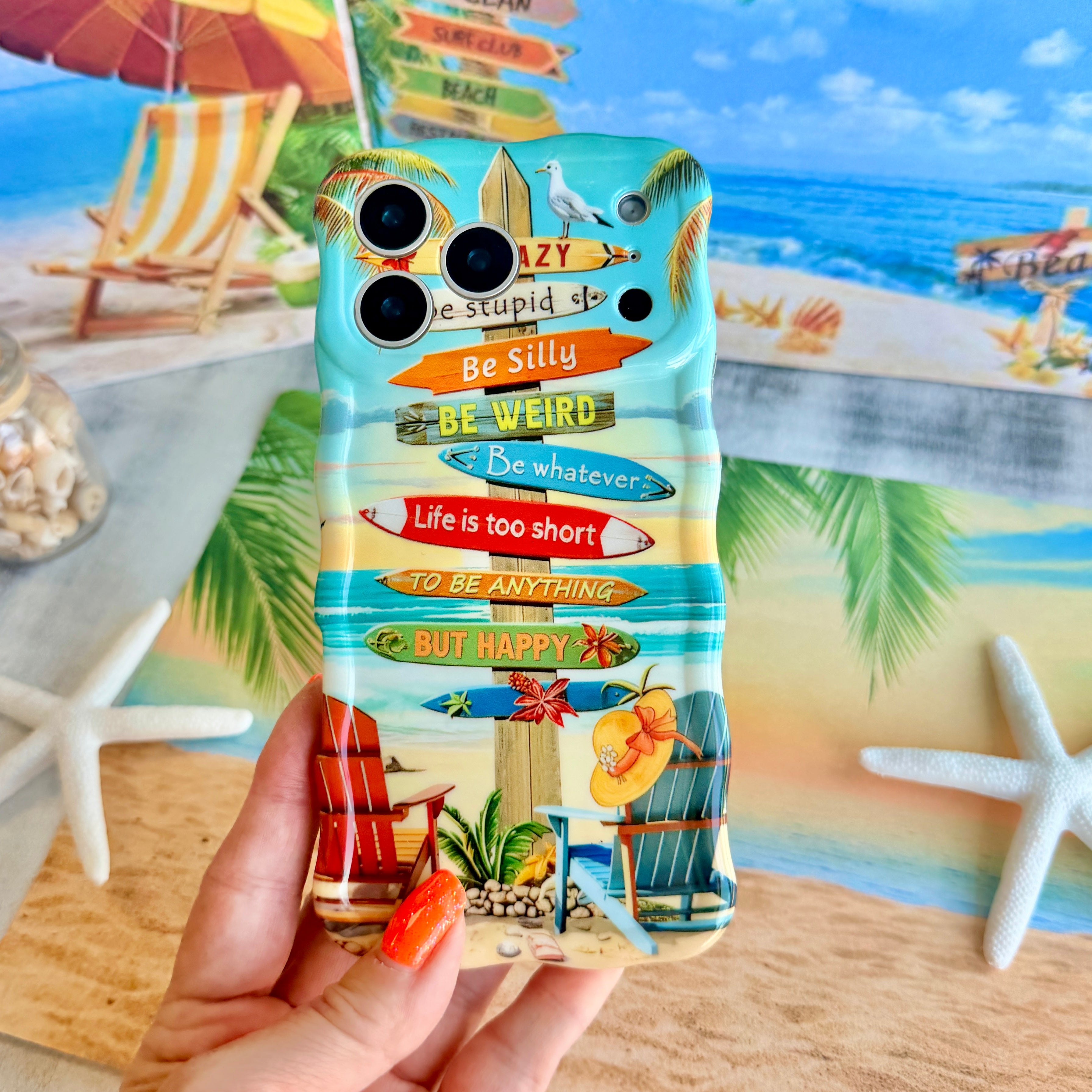Trendy wavy iPhone case featuring a beach scene with colorful surfboard signs and a "Life is too short to be happy" quote with a high-gloss finish.