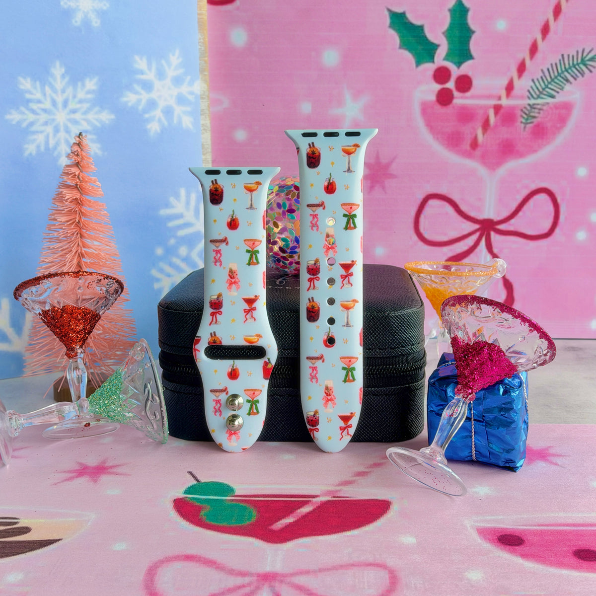 Both Holiday Spirits, Please? Apple Watch band straps on a black jewelry box with a pink bottle-brush tree and cocktail glasses