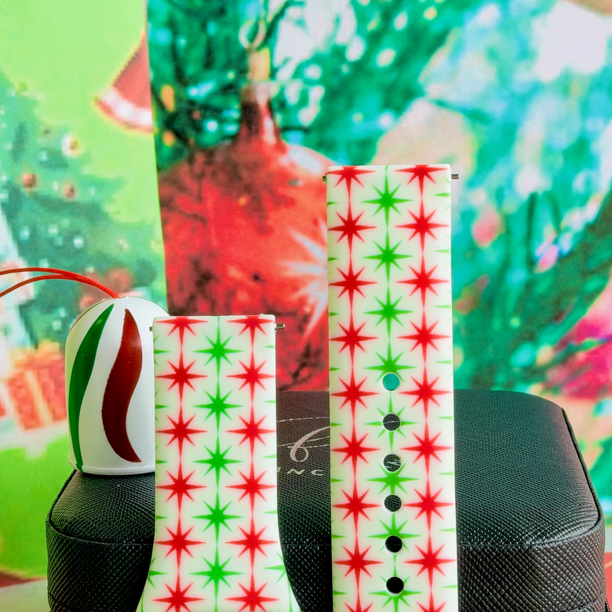 Close-up of both Tinsel & Stardust Samsung Galaxy Watch band straps with red and green retro starbursts