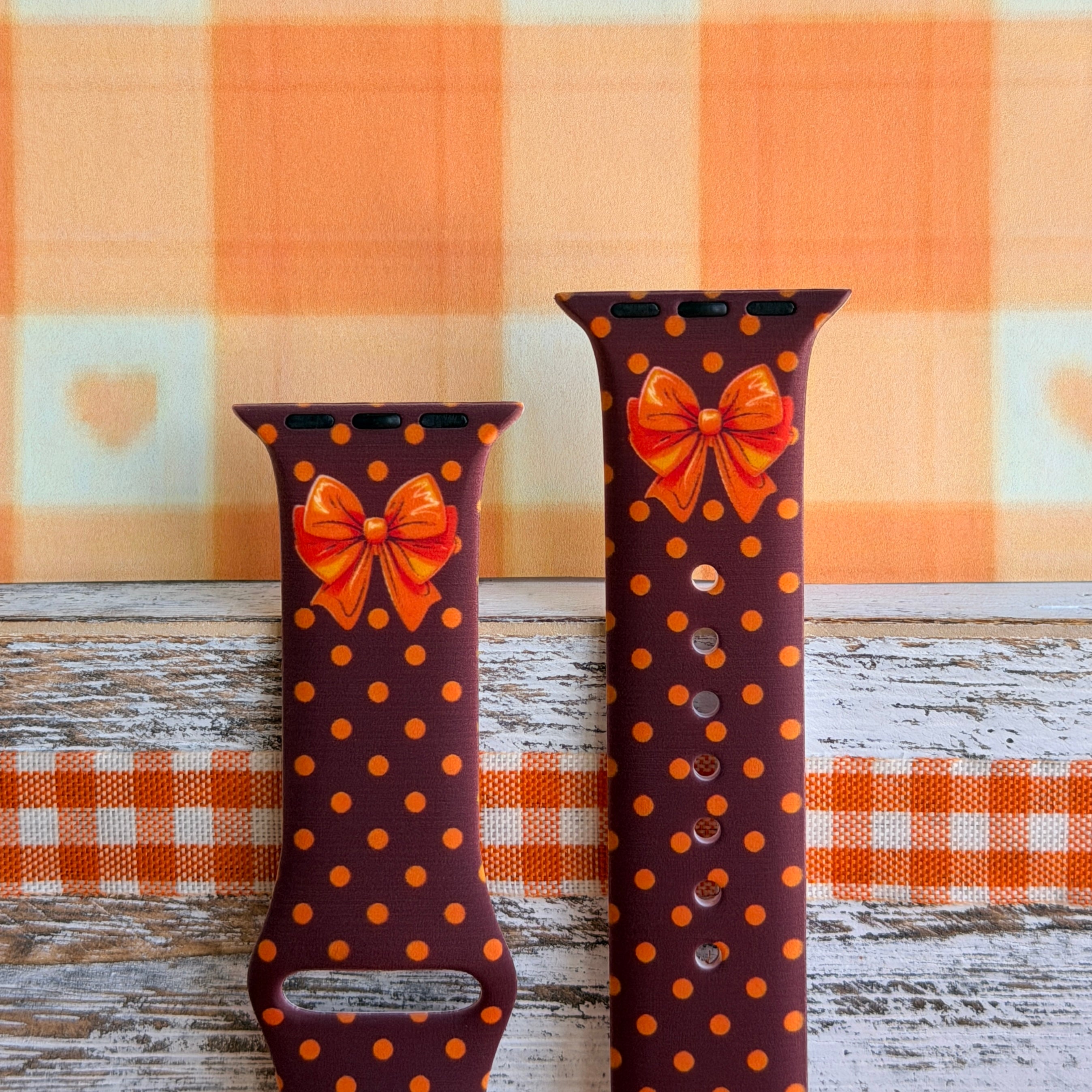 Spotted Looking Cute Apple Watch band front view of both strap halves, showing the orange bow near the top of each half and the polka dot print running the full length.