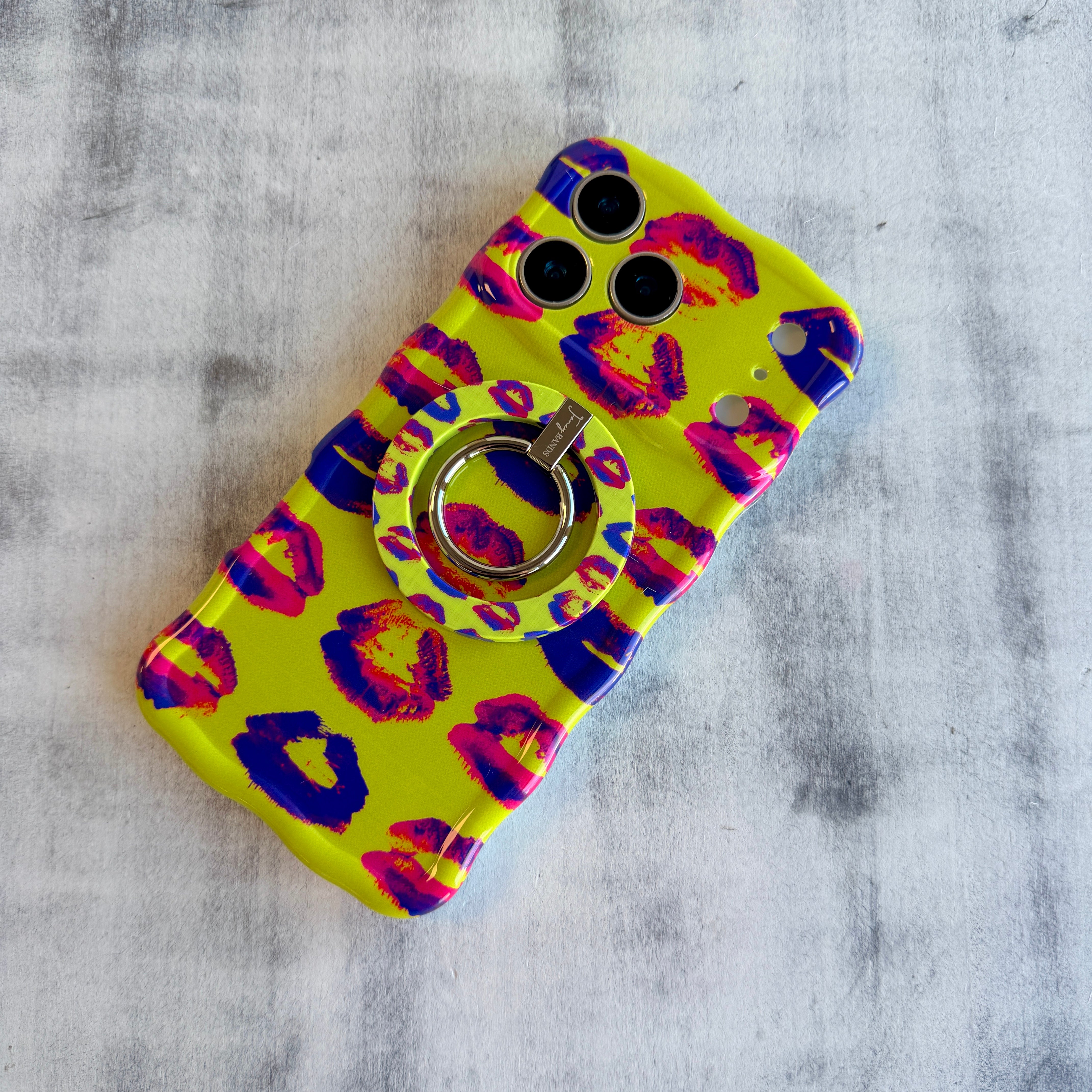 Lip Pop pattern MagSafe phone grip ring with neon pink and purple lip prints on bright yellow background compatible with iPhone and Samsung