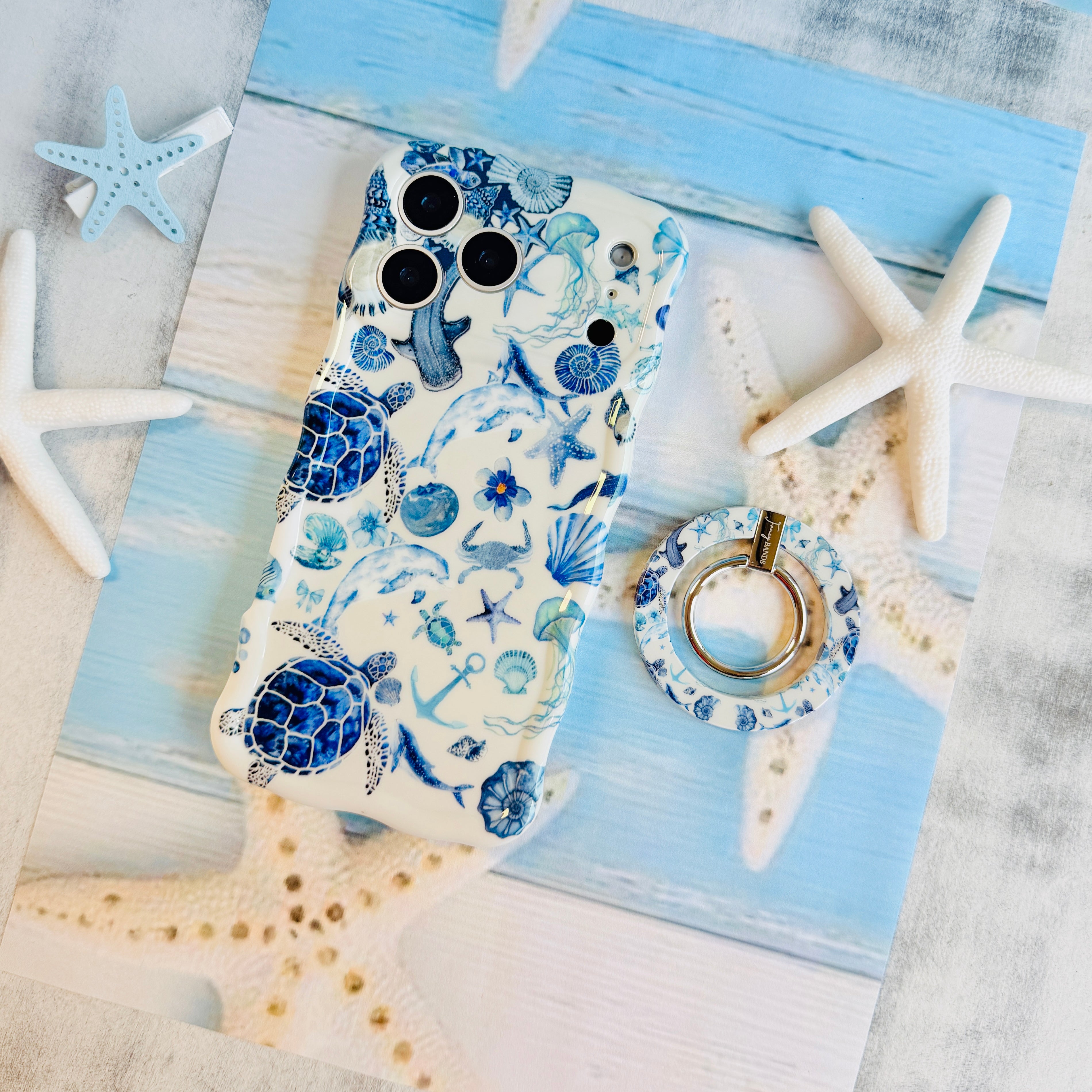 Blue Lagoon nautical watercolor MagSafe phone grip ring with sea turtles, whales, and jellyfish in shades of blue on a white background compatible with iPhone and Samsung