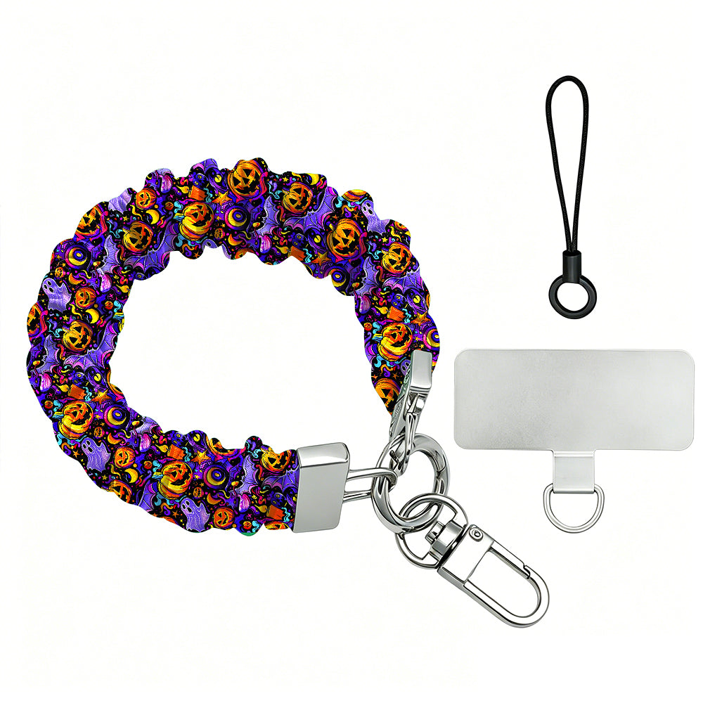 Size diagram for the Jack-O-Lantern Jive scrunchie phone wrist strap, purple with neon pumpkins, showing the 26.5 cm loop and 2.5 cm width.