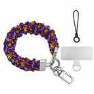 Size diagram for the Jack-O-Lantern Jive scrunchie phone wrist strap, purple with neon pumpkins, showing the 26.5 cm loop and 2.5 cm width.