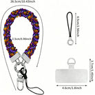 Jack-O-Lantern Jive scrunchie phone wrist strap shown with its metal clasp and phone attachment tab, purple fabric printed with glowing pumpkins and ghosts.