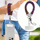 Jack-O-Lantern Jive scrunchie phone wrist strap worn on the wrist and clipped at the hip, with a close-up of the purple neon pumpkin print.