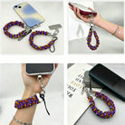Four views of the Jack-O-Lantern Jive scrunchie phone wrist strap attached to a phone, worn on a wrist, and resting on a desk.