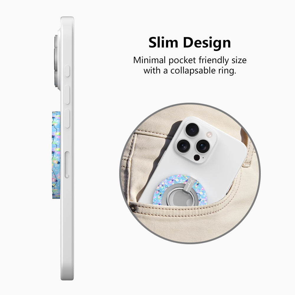 Side view of the slim Twinkle All The Way grip ring with collapsible ring, and a phone with the Christmas lights grip sliding into a jeans pocket