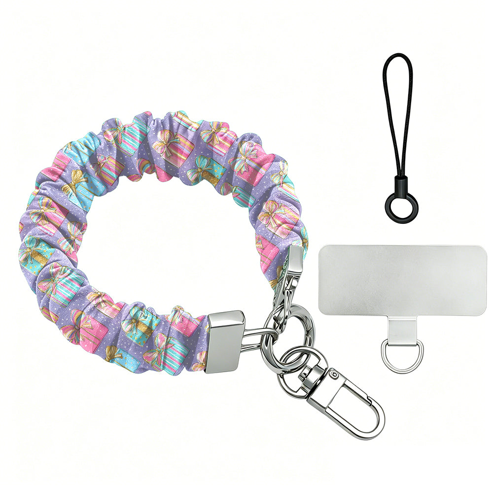 No Peeking, Darling scrunchie phone wrist strap laid flat with silver clasp and phone tab, pastel presents on lavender