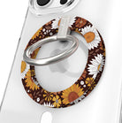 Harvest Sunflowers Hold It Fancy MagSafe grip ring close-up on a clear iPhone case, showing the chocolate brown base packed with retro sunflowers and white daisies around the silver rotating ring.