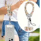 Vintage Christmas scrunchie wrist strap worn on the wrist with an iPhone hanging from it, plus close-up of the strap and phone tab