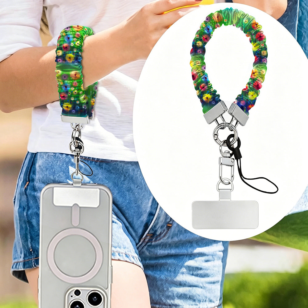 Petal Princess scrunchie phone wrist strap worn on the wrist with a MagSafe iPhone case, painted rainbow wildflower print from Fancy Bands