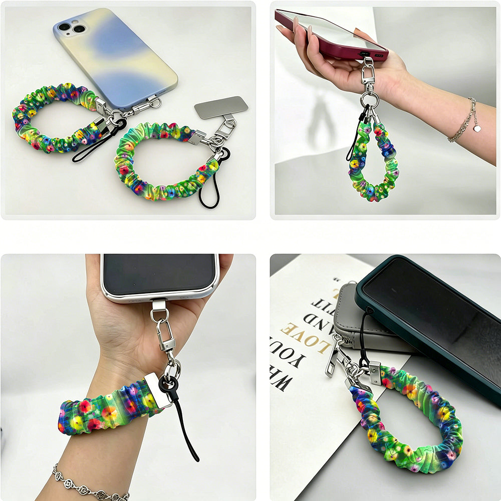 Petal Princess scrunchie phone wrist strap shown from four angles - clipped to an iPhone, held in hand, worn on the wrist and laid flat - in a painted rainbow wildflower print