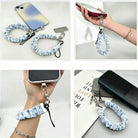 Four views of the Snow Pretty In Blue scrunchie phone wrist strap: with its phone tab, dangling from a phone in hand, worn on the wrist, and clipped to a bag