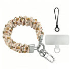 Boot Scootin' Christmas scrunchie phone wrist strap laid flat with silver clasp and phone tab, cowboy boots and hats on cream