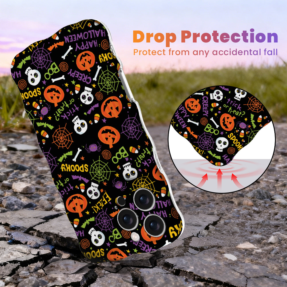 Drop protection diagram for the Spooky Wavy Luxe MagSafe iPhone case, black with orange pumpkins and skulls, showing the cushioned corner on pavement.
