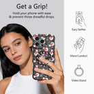 Woman taking a selfie while holding an iPhone by the Snowman grip ring; easy selfies, more comfort and video stand