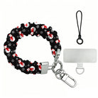 Snowman scrunchie phone wrist strap laid flat with silver clasp and phone tab, black print with white snowmen in red scarves and Santa hats