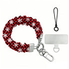 Buffalo Plaid Snowflake scrunchie phone wrist strap laid flat with silver clasp and phone tab, red and black buffalo check with white snowflakes