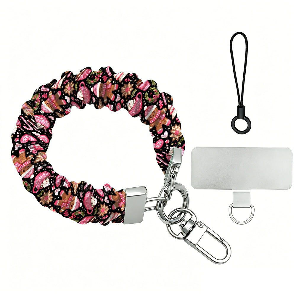 Merry Mugs & Ginger Hugs scrunchie phone wrist strap laid flat with silver clasp and phone tab, black gingerbread print with pink cocoa mugs and candy canes