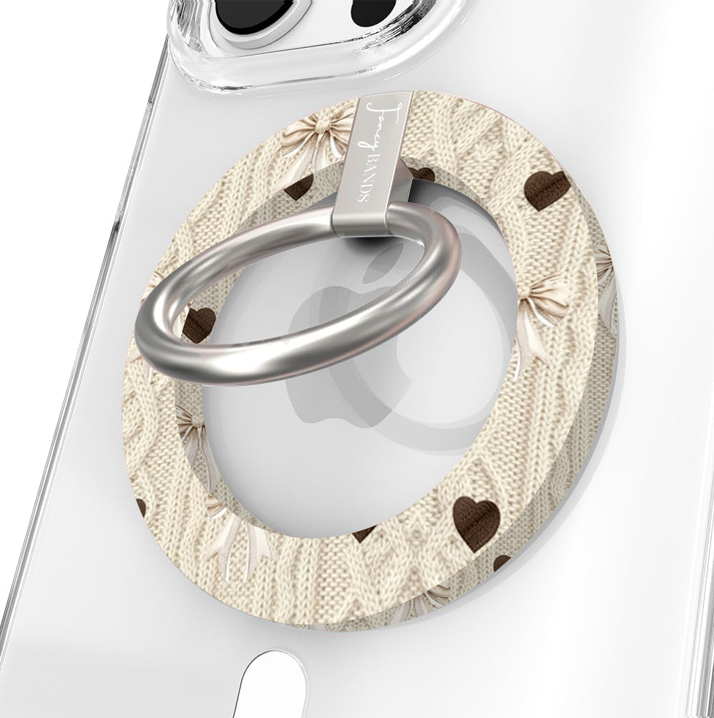 Sweater Weather Sweetheart Hold It Fancy MagSafe grip ring featured hero shot with cream cable-knit print, taupe bows, and brown hearts from Fancy Bands.
