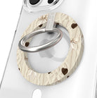 Sweater Weather Sweetheart Hold It Fancy MagSafe grip ring featured hero shot with cream cable-knit print, taupe bows, and brown hearts from Fancy Bands.