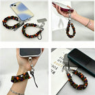 Four views of the Spooky scrunchie phone wrist strap attached to a phone, worn on a wrist, and resting on a desk.