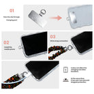 Three-step installation diagram for the Spooky scrunchie phone wrist strap, showing the tab inserted through the charging port and the strap clipped on.
