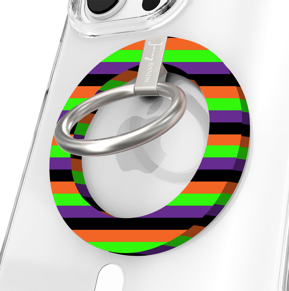 Main Witch Energy Hold It Fancy MagSafe grip ring shown on a clear iPhone case, striped in black, purple, neon green and orange around the silver rotating ring.