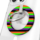 Main Witch Energy Hold It Fancy MagSafe grip ring shown on a clear iPhone case, striped in black, purple, neon green and orange around the silver rotating ring.