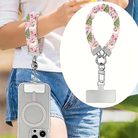 Jolly Pink Santa scrunchie wrist strap worn on the wrist with an iPhone hanging from it, plus close-up of the strap and phone tab
