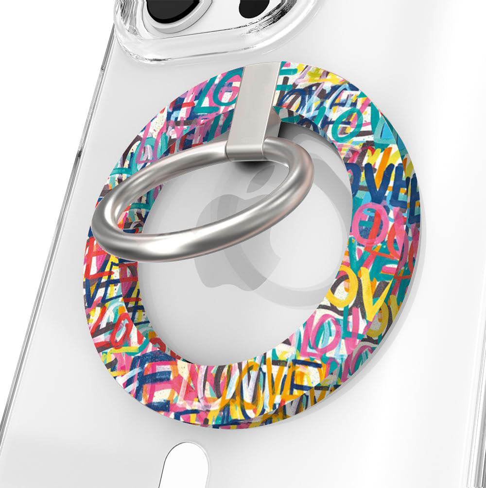 Love Riot graffiti street art MagSafe phone grip ring with colorful love text in pink teal and yellow on white background compatible with iPhone and Samsung