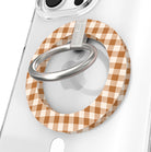Gingham Pumpkin Girly Hold It Fancy MagSafe grip ring close-up on a clear iPhone case, showing the caramel and cream gingham check around the silver rotating metal ring.