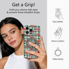 Woman taking a selfie while holding an iPhone by the Plaid Tidings & Bows grip ring; easy selfies, more comfort and video stand