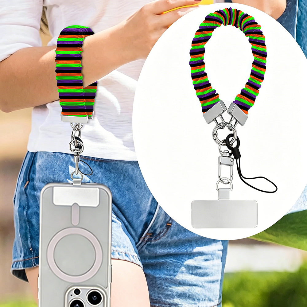 Main Witch Energy scrunchie phone wrist strap worn on the wrist and clipped at the hip, with a close-up of the striped fabric.
