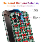 Plaid Tidings & Bows iPhone case with 1 mm raised screen edges and 1.5 mm raised camera lens edges, cherry-red bows on evergreen check