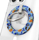 The Bewitching Hour Hold It Fancy MagSafe grip ring shown on a clear phone case, periwinkle blue with orange pumpkins, witch hats and owls.