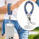 The Bewitching Hour scrunchie phone wrist strap in periwinkle blue witch print, worn on the wrist with the phone hanging