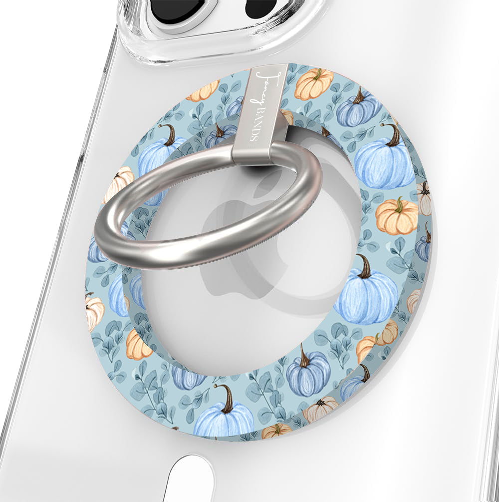 Blue Belle Pumpkin Patch Hold It Fancy MagSafe grip ring close-up on a clear iPhone case, showing the dusty blue ring with watercolor pumpkins and sage leaves around the silver rotating ring.